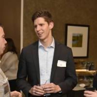 Three alumni talking at the event.